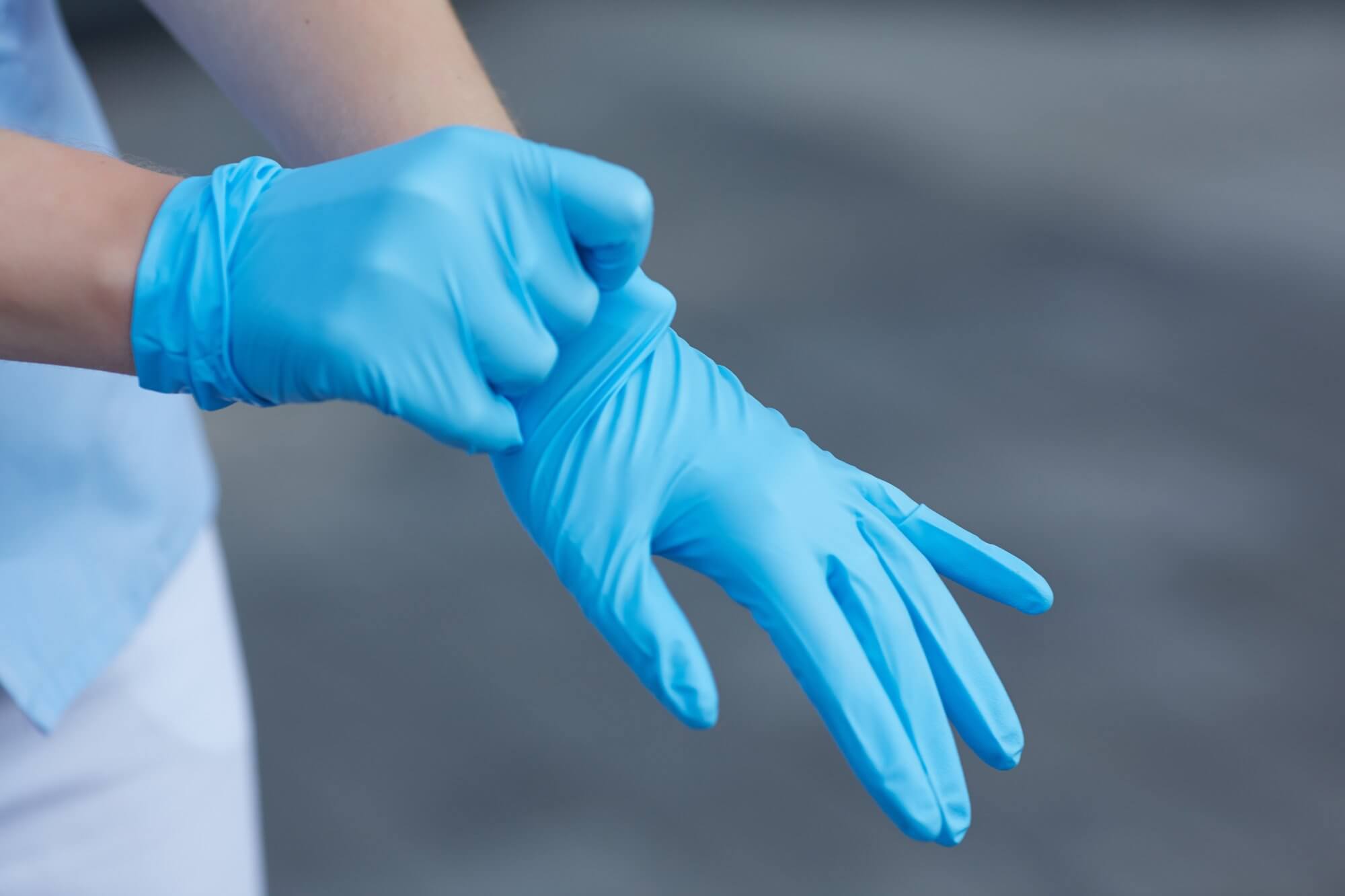 person putting medical gloves on