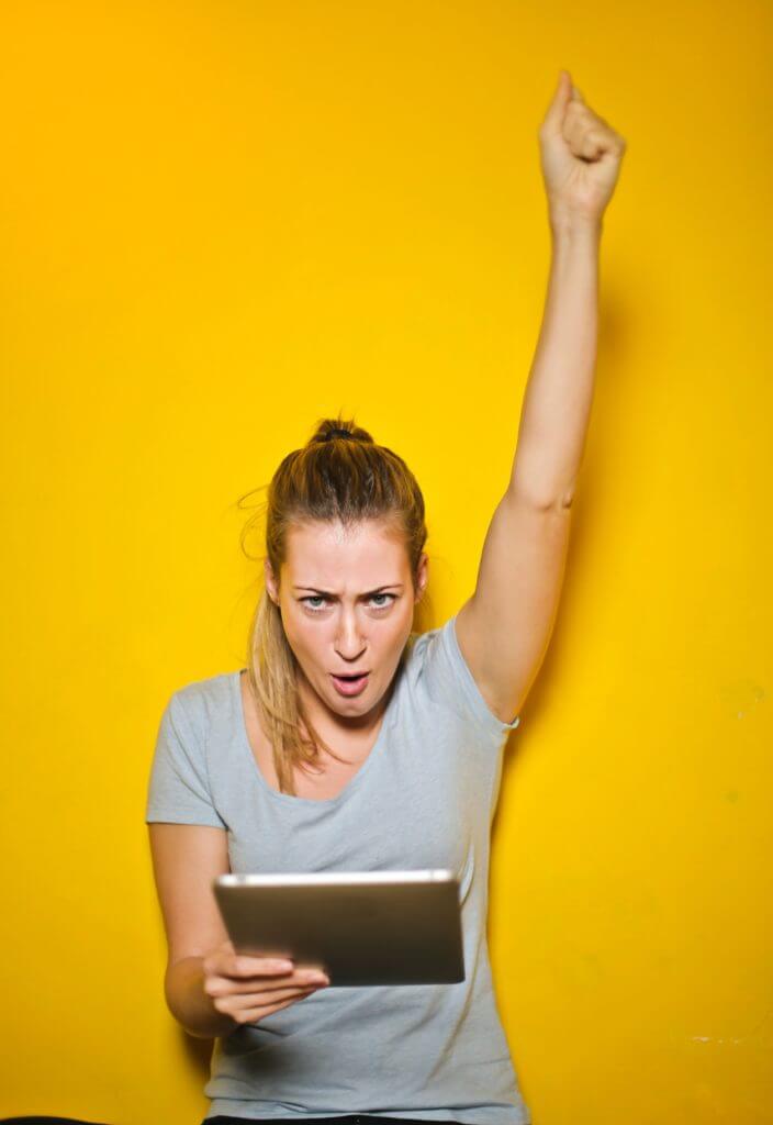 woman looking at laptop and excited