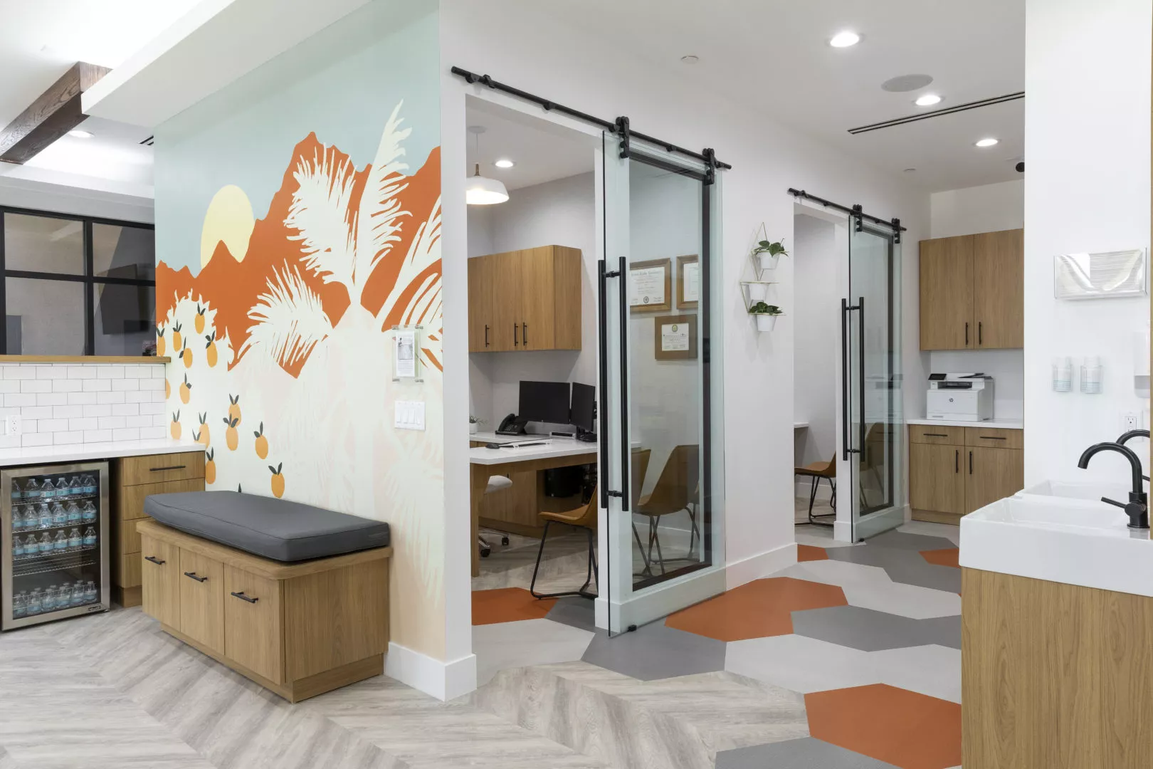 An alternate view of the mural painted by Devin Johnson. To the right, there are offices with sliding glass doors.
